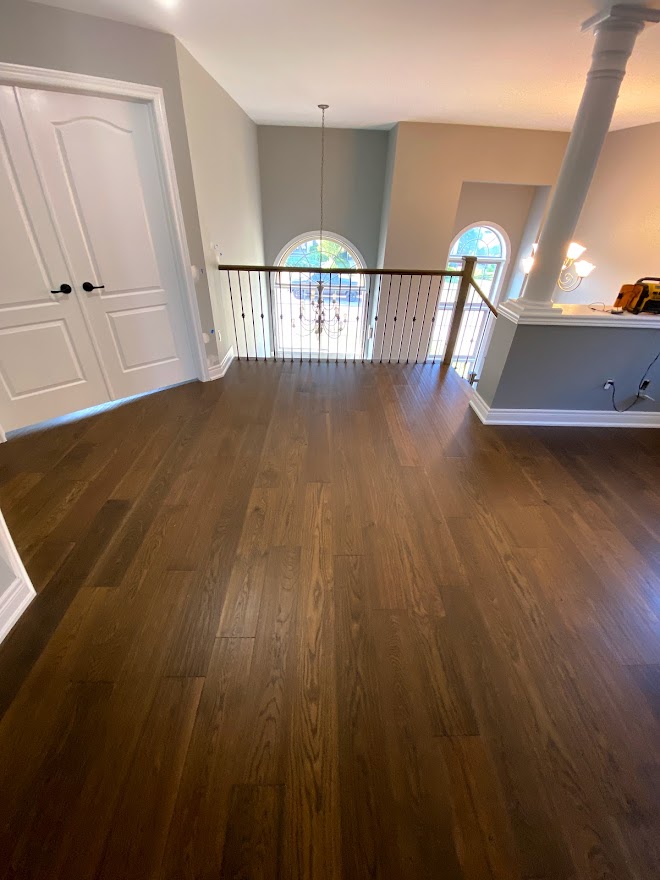 Hardwood Floor Installation in Hamilton, Ontario that has been stained dark in the upstairs of a house.